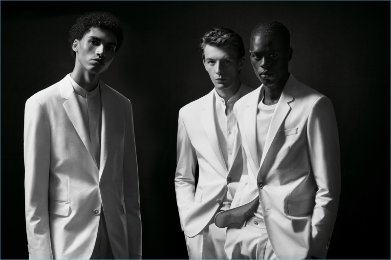 Models Sol Goss, Finnlay Davis, and Alpha Dia don white suits from BOSS capsule collection.
