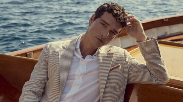 Alexandre Cunha models a Brunello Cucinelli striped linen and virgin wool suit.